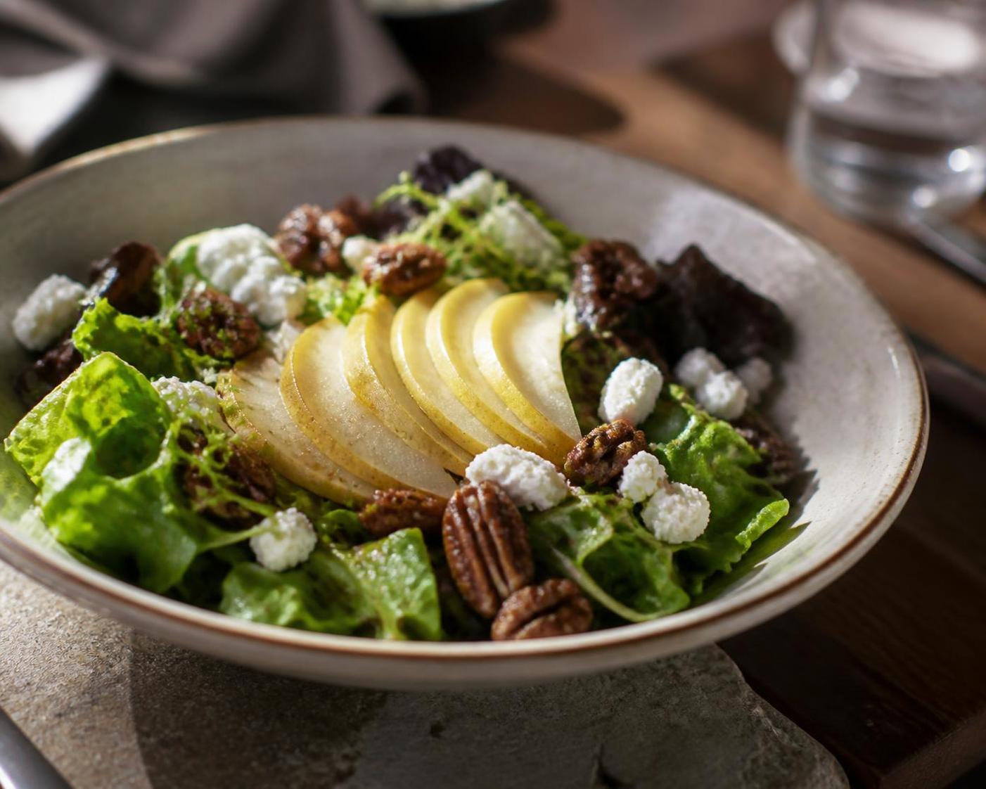 House salad with sliced pear, pecans, and goat cheese